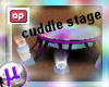 Lit couple cuddle stage